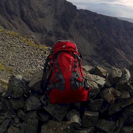 Image of a packed Deuter Guide Lite 32+ perched on the edge of the Cairn marking the base of the final ascent up Inaccessible Pinnacle.
