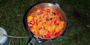 Image of Mexican Fried Rice in a camping pot simmering over a stove.
