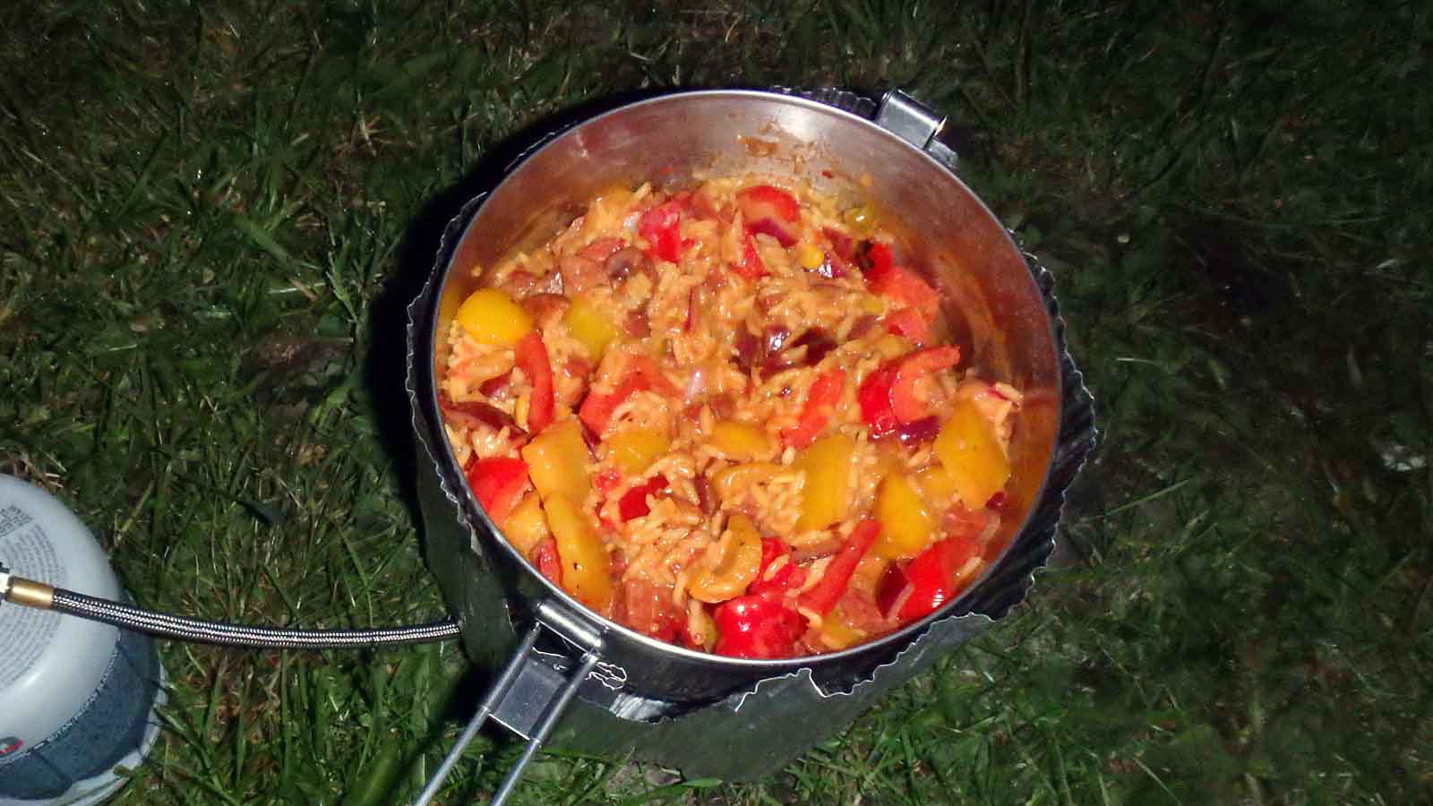 Image of Mexican Fried Rice in a camping pot simmering over a stove.