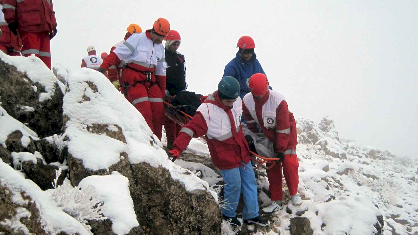 Mountain Rescue team evacuating a stretcher casualty off the mountain in snowy terrain.