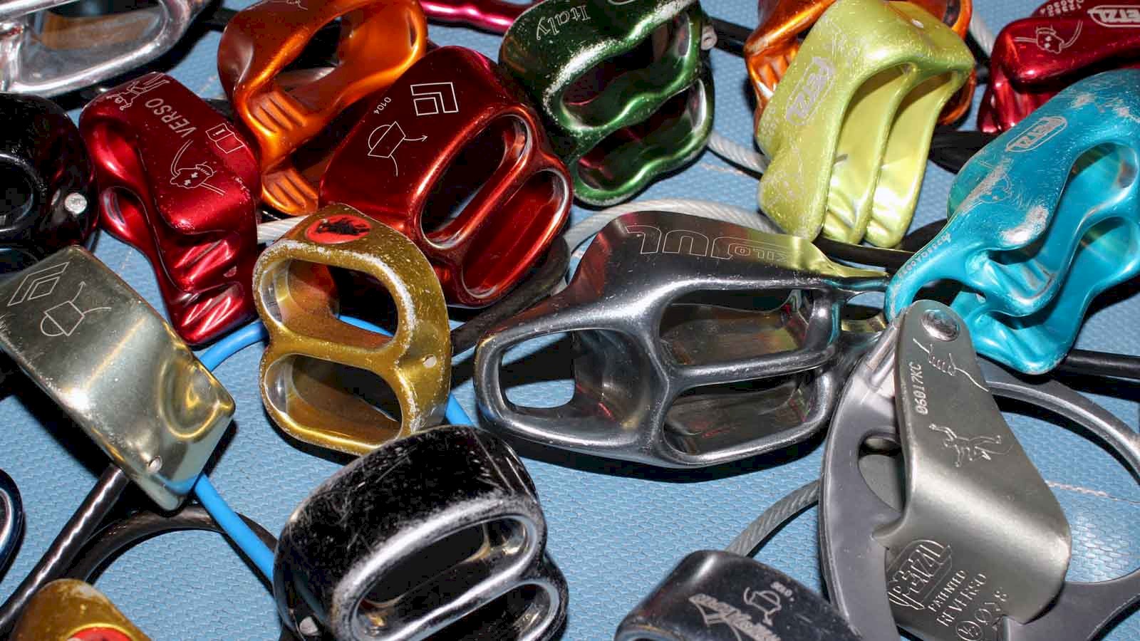 Image of a variety of tube belay devices as used by many climbers in the UK.