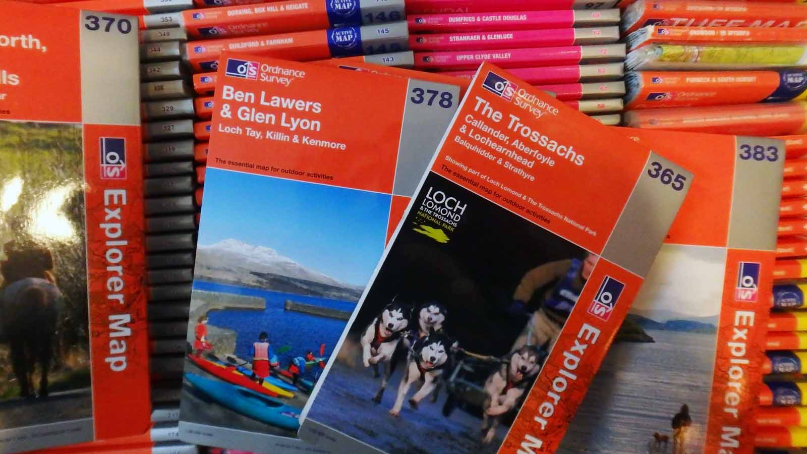 A selection of OS Explorer maps pulled form a larger archive sitting underneath.